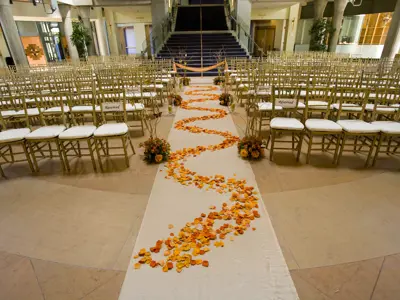lobby transformed into a wedding with flowers along a carpet